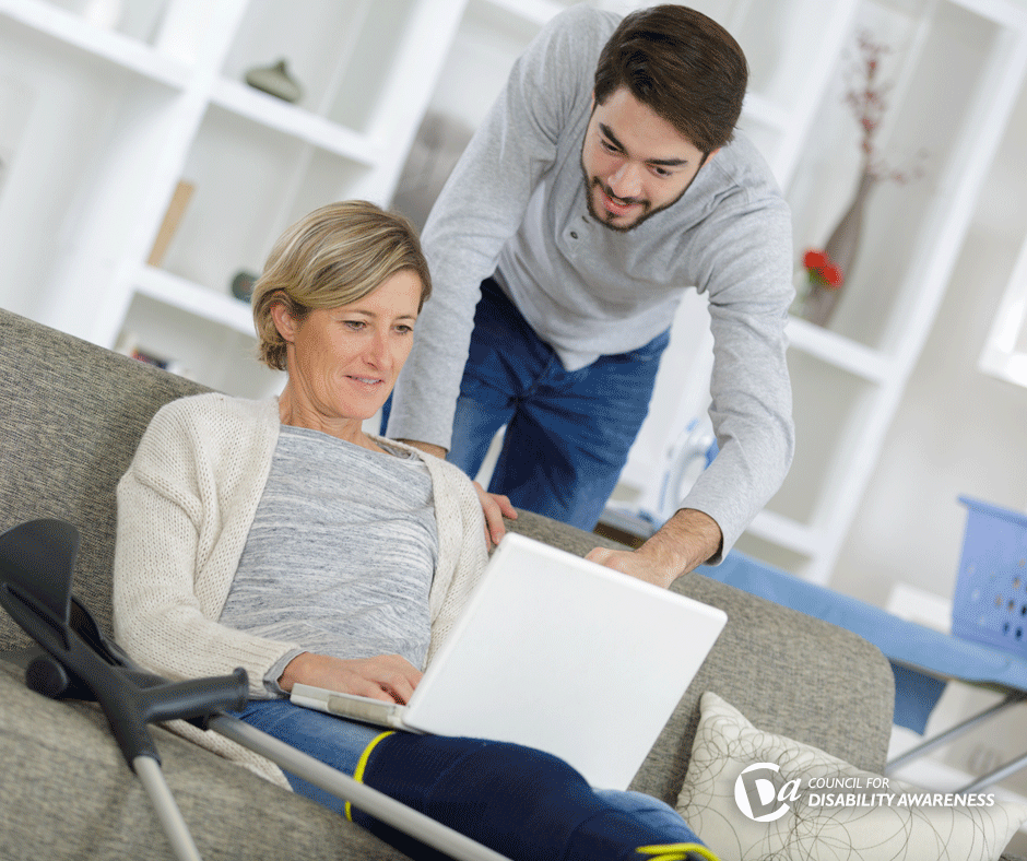 Woman with crutches sitting on a sofa