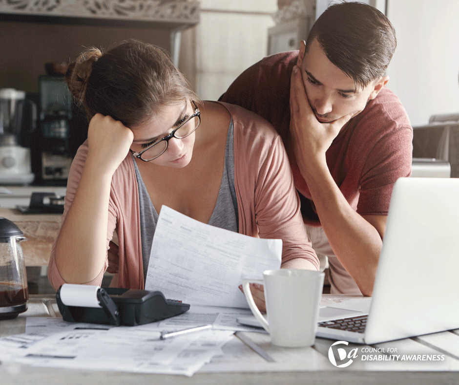 Couple working on their paperwork at a table.