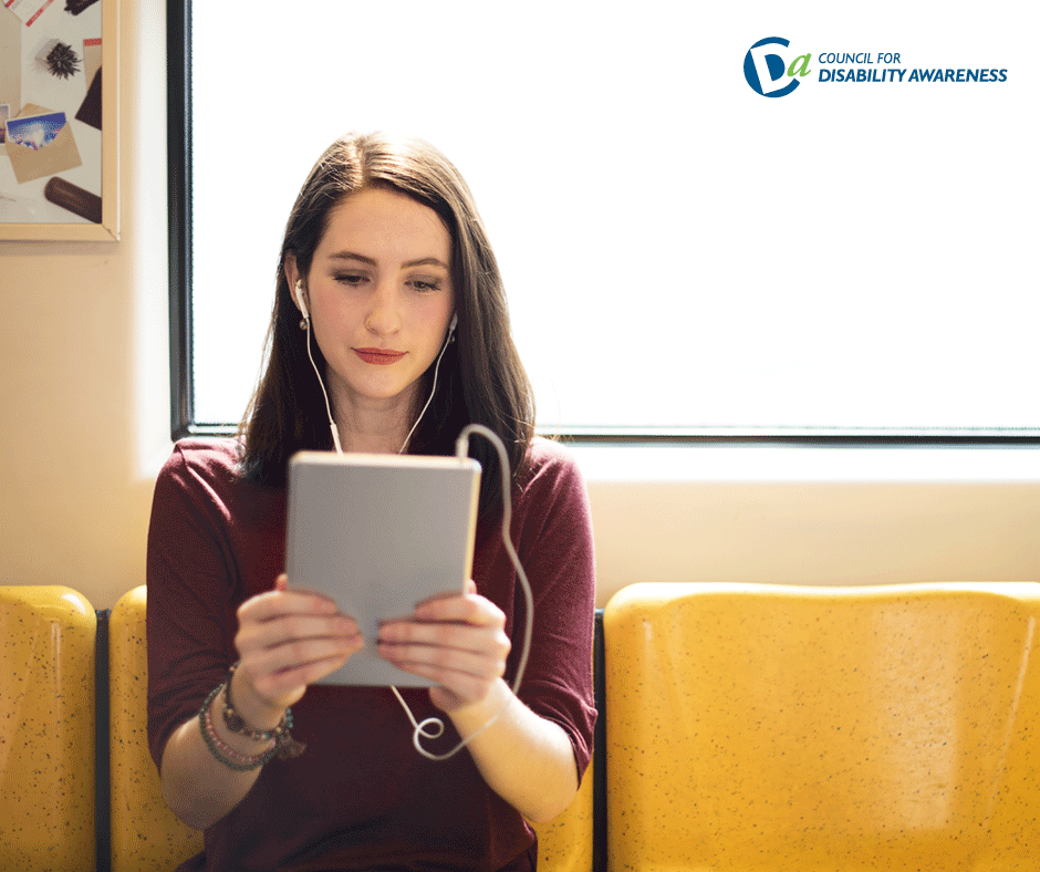 Woman reading tablet on train.