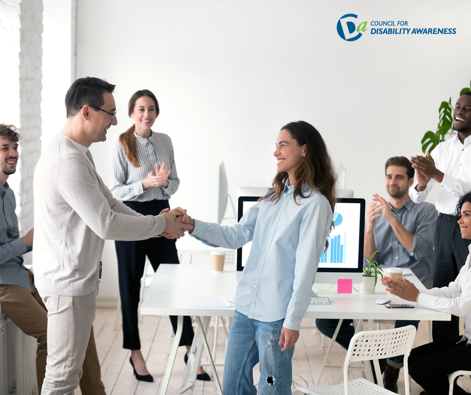 Team of people, with people at center shaking hands