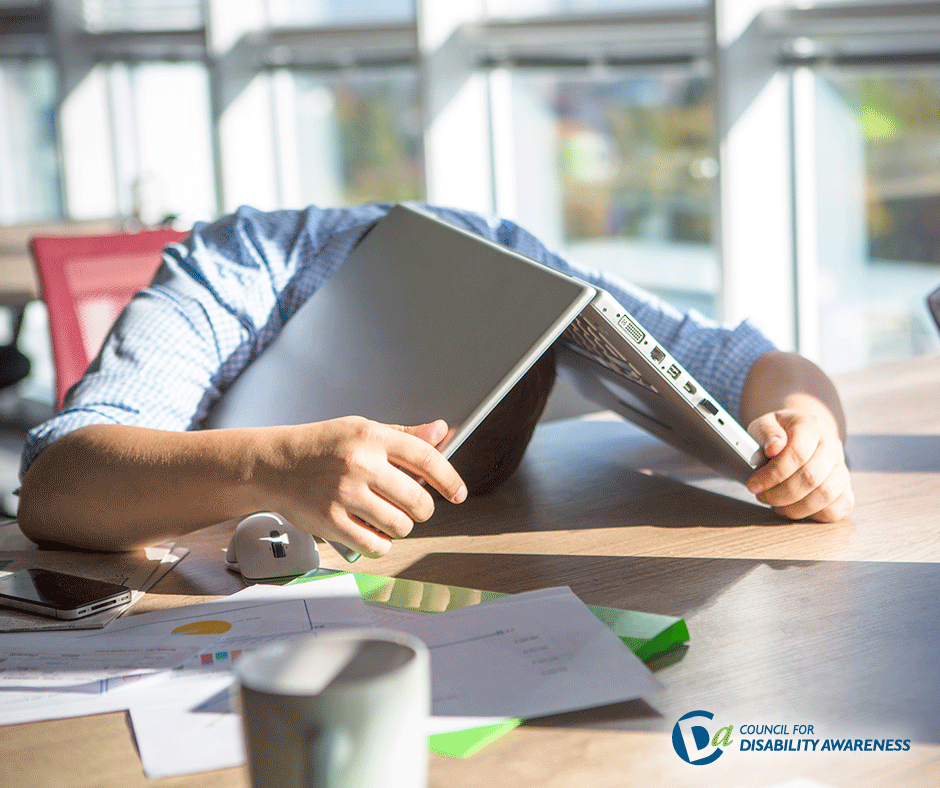 Overworked young professional with his head on the desk