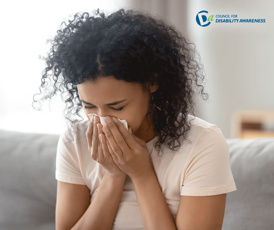 Young woman suffering from allergies in her home