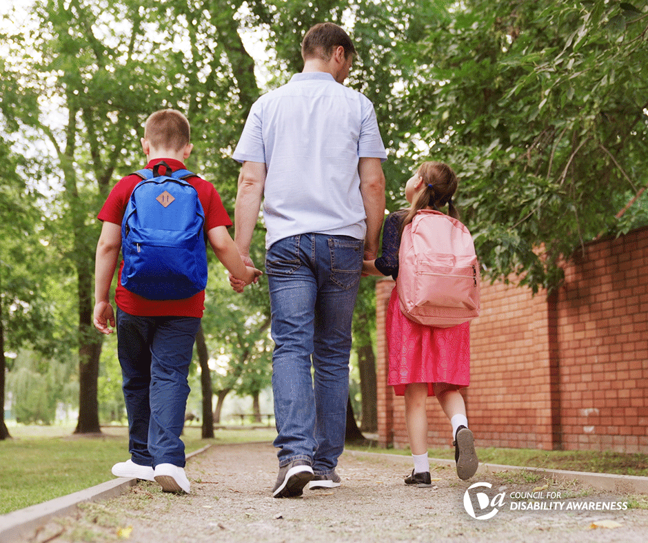 A father walks his kids to their first day of school