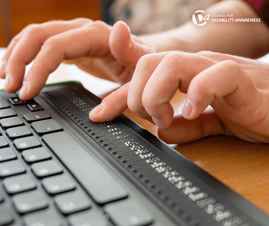 fingers on a braille keyboard