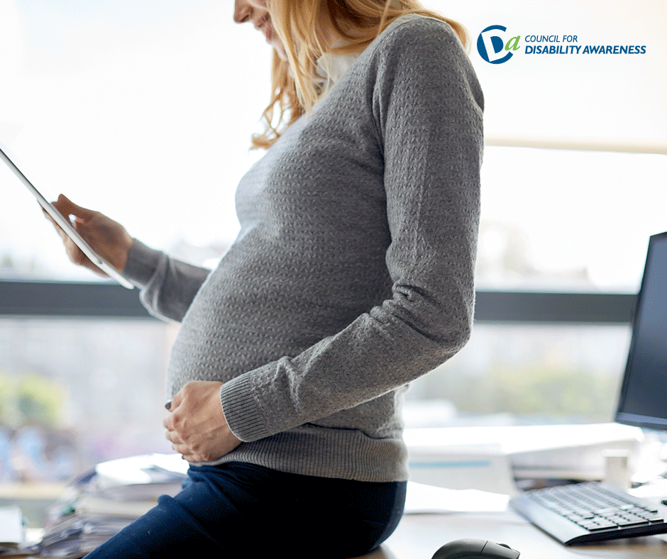 Pregnant woman at work in the office