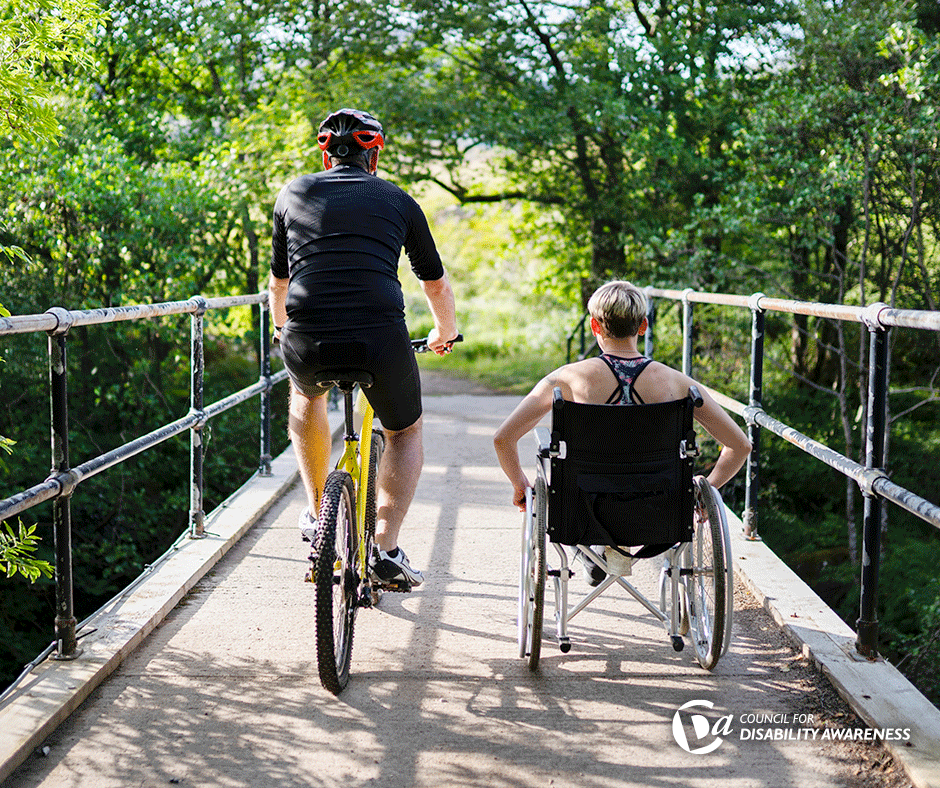 Couple out for a ride on a bike and a wheelchair