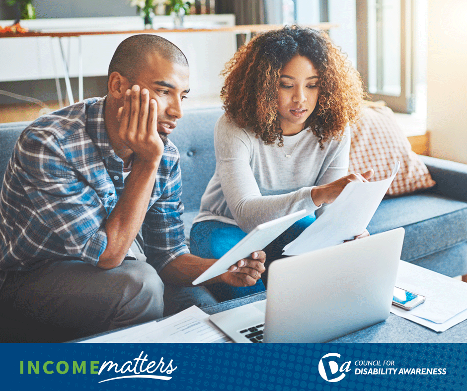 Young couple in their living room review budget paperwork. Income Matters.