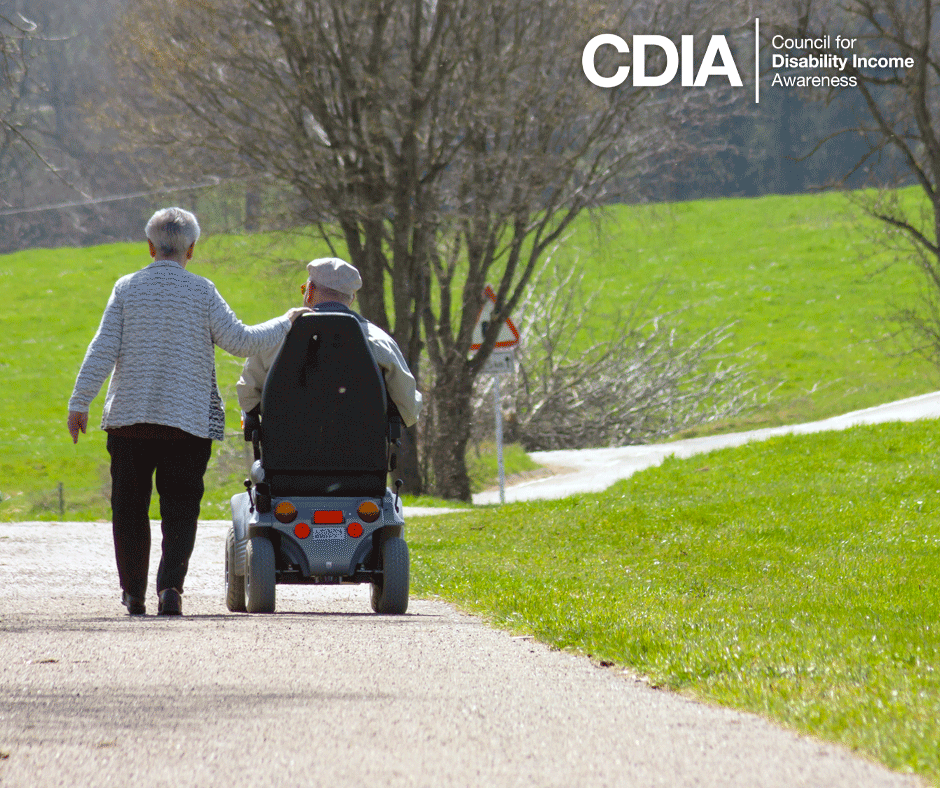 Mature couple out for a stroll, gentleman is in a motorized wheelchair