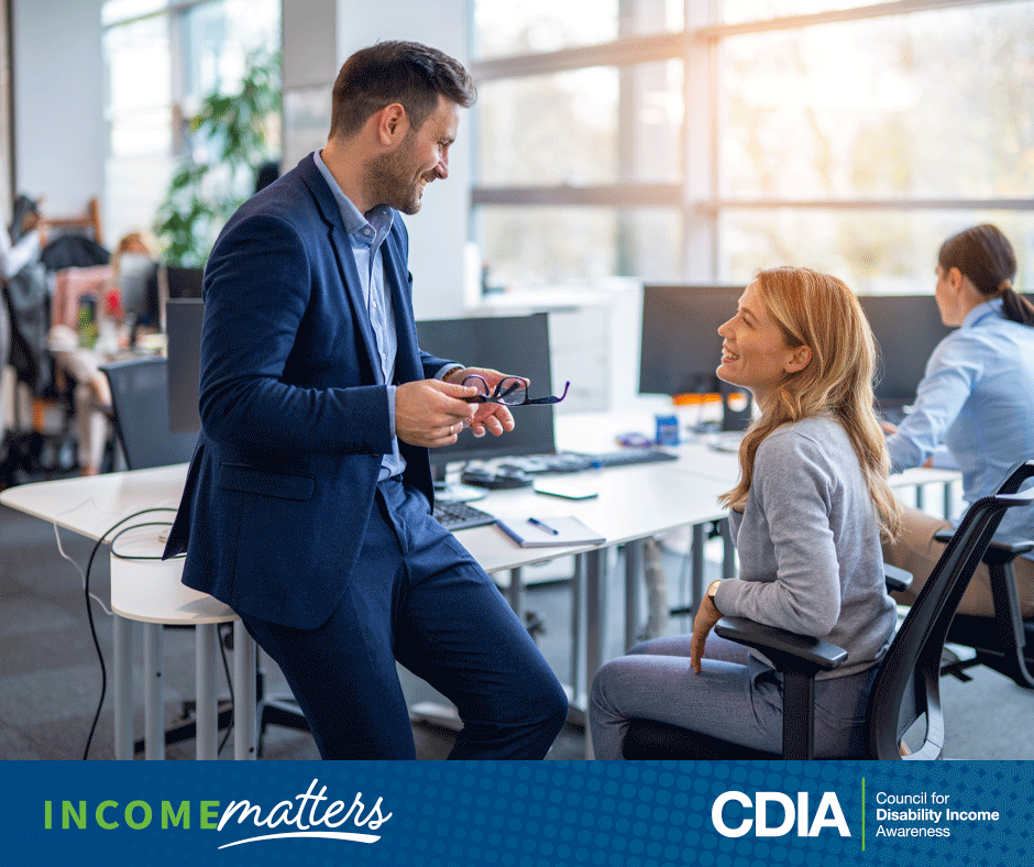 Income Matters, CDIA. Casual meeting between two professionals in the office.