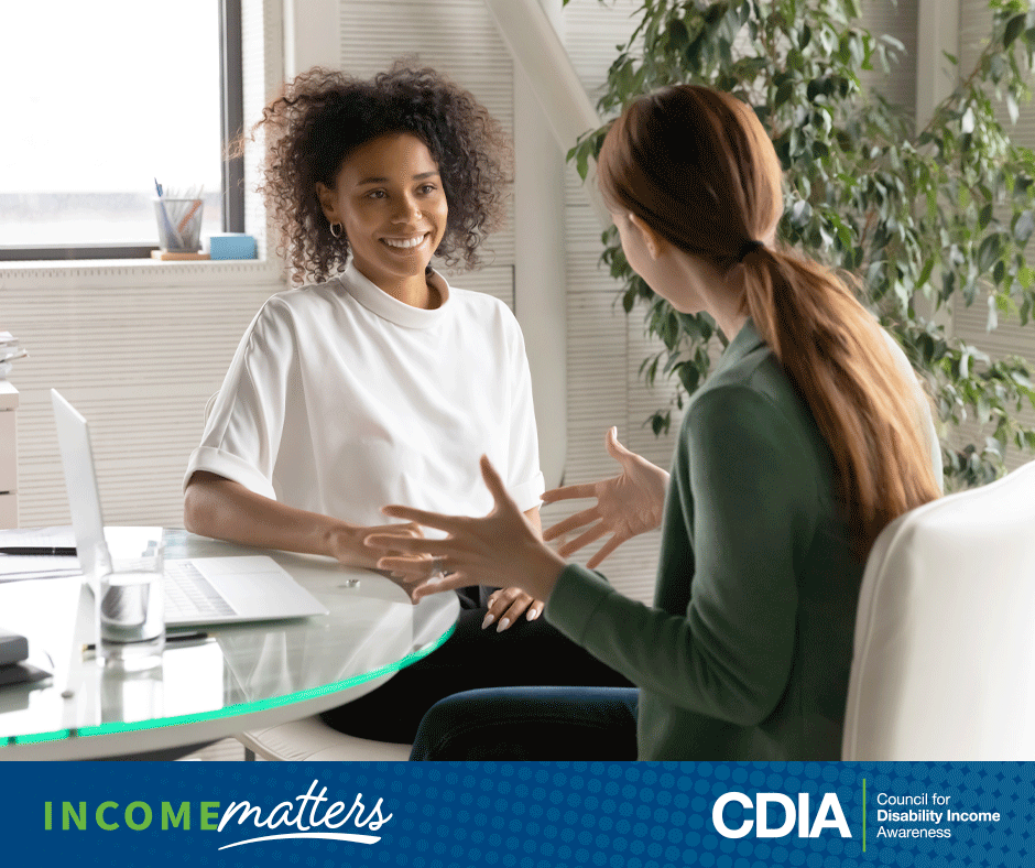Income Matters, CDIA. Two employees discussing voluntary benefit options at work.