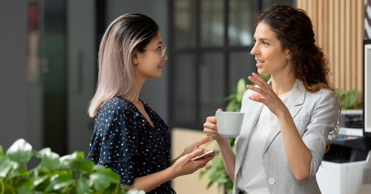 Two employees discussing benefits